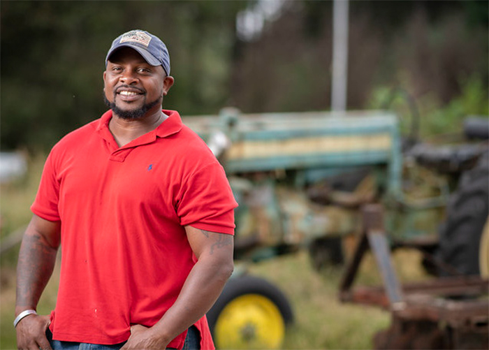 Veteran Farmer with tractor in background